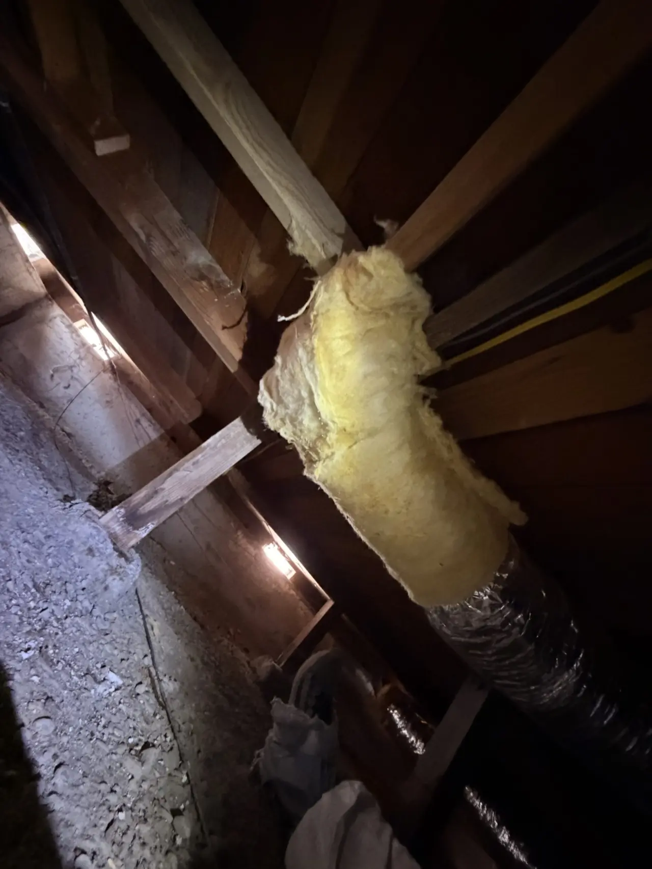 Insulated flex duct joint in the crawlspace of a San Bruno heat pump installation