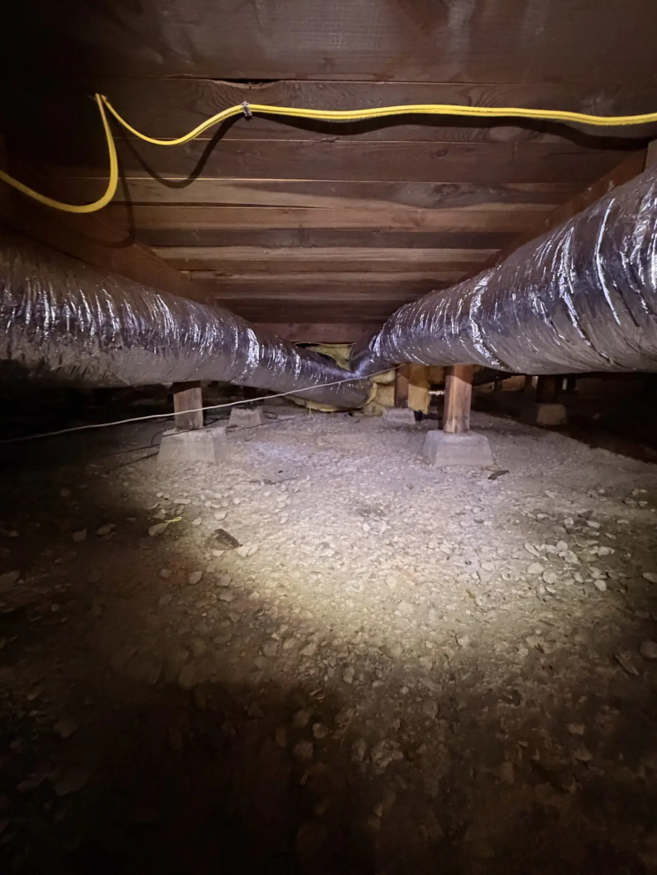 New insulated ductwork run in a San Bruno crawlspace during heat pump installation