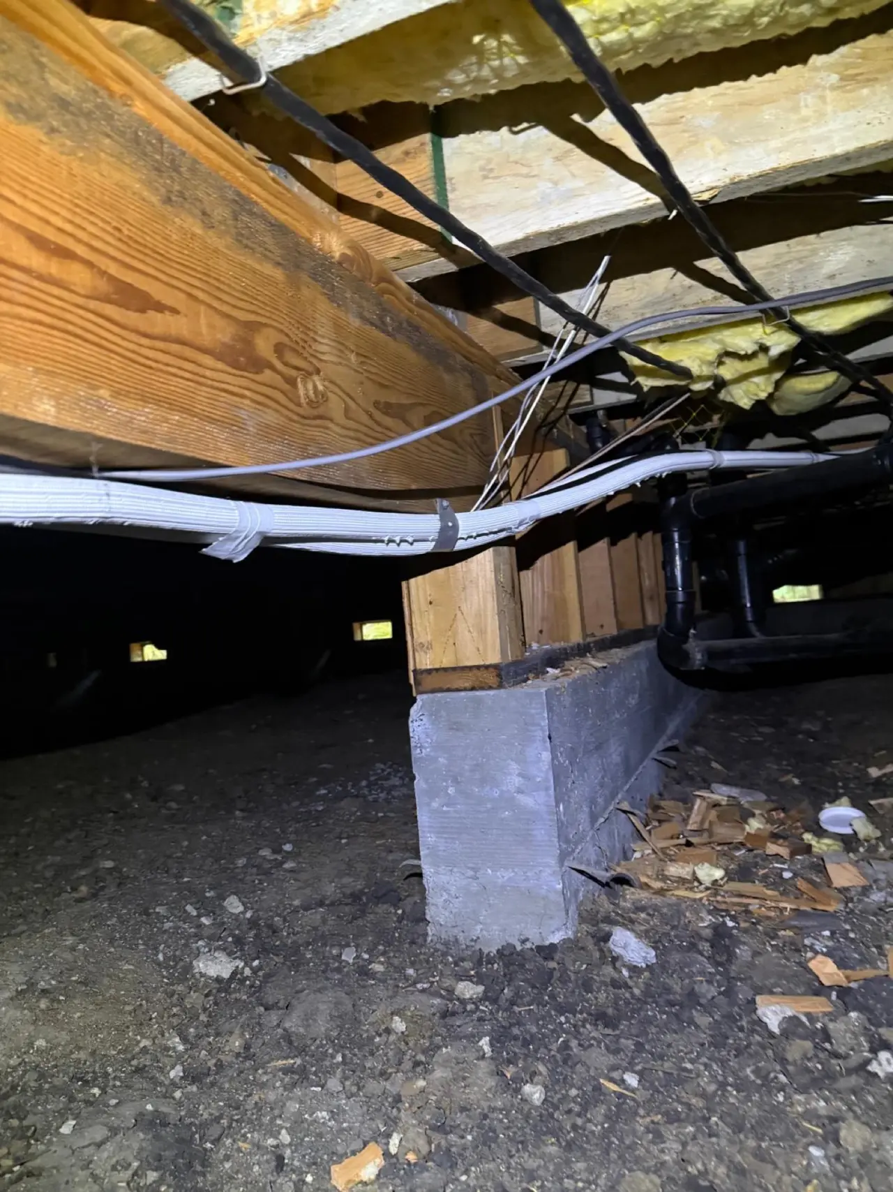 Insulated refrigerant line sets and wiring strapped to floor joists in a Palo Alto crawlspace