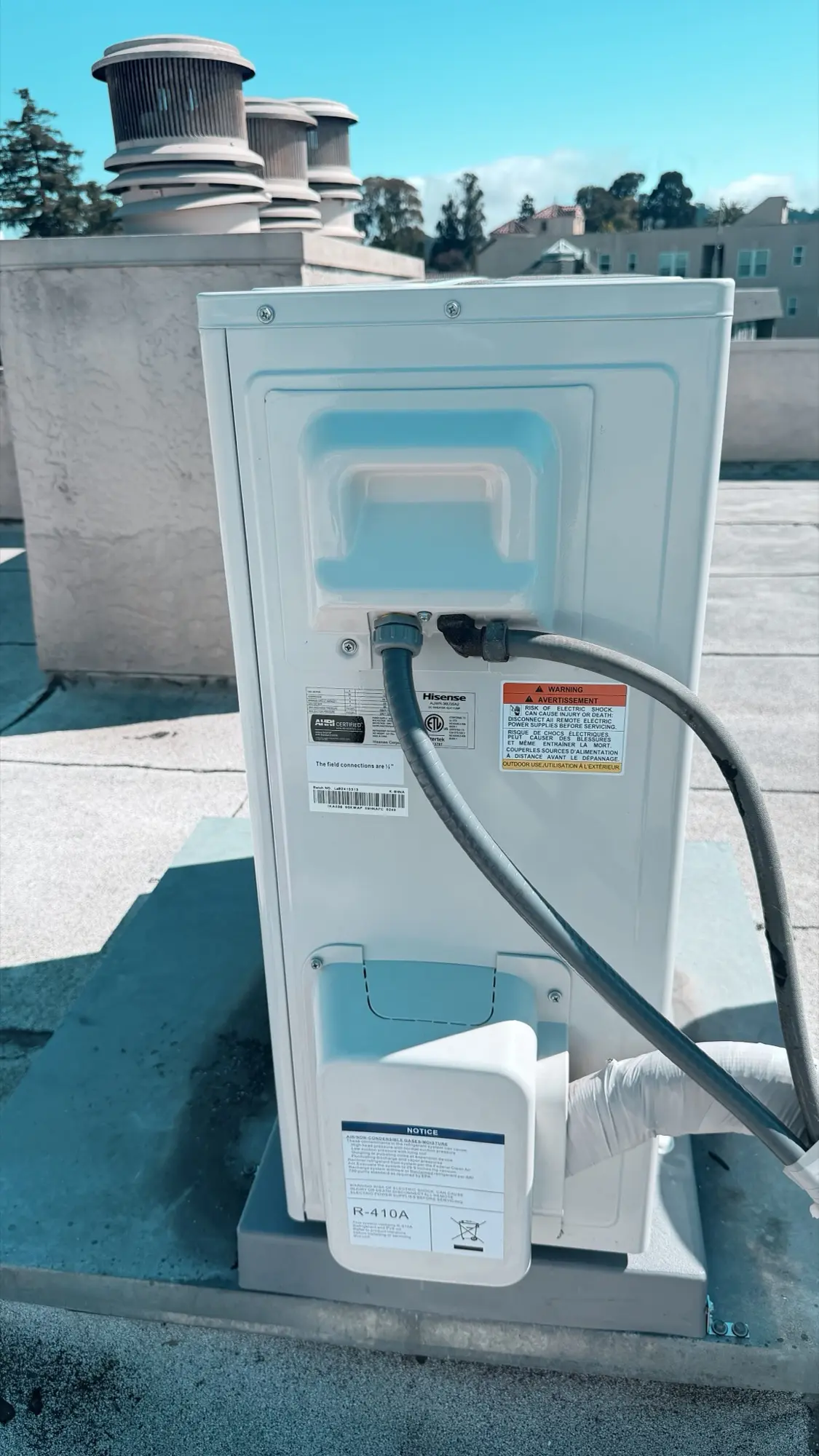 Electrical whip and refrigerant connections on a Hisense heat pump in Burlingame