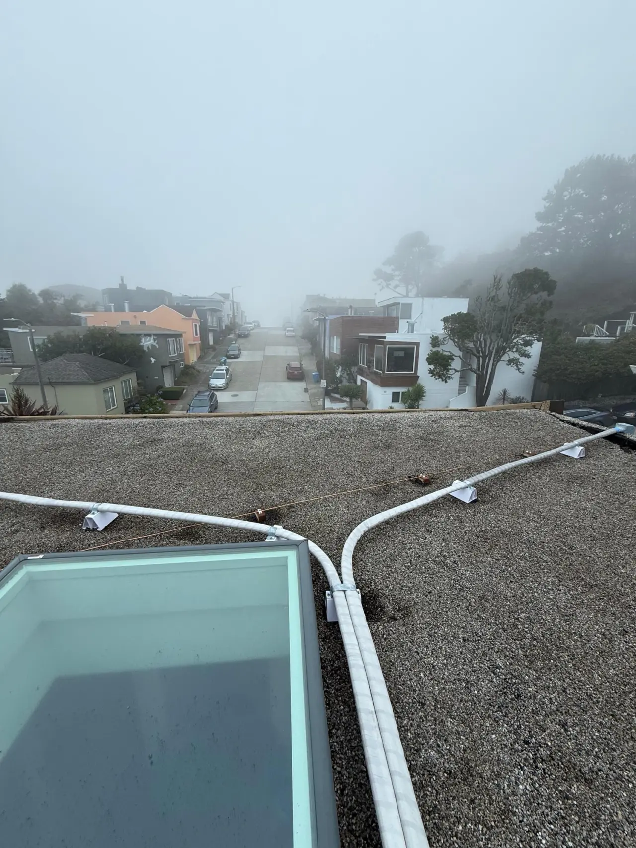 Insulated mini-split line sets routed across a San Francisco rooftop during installation