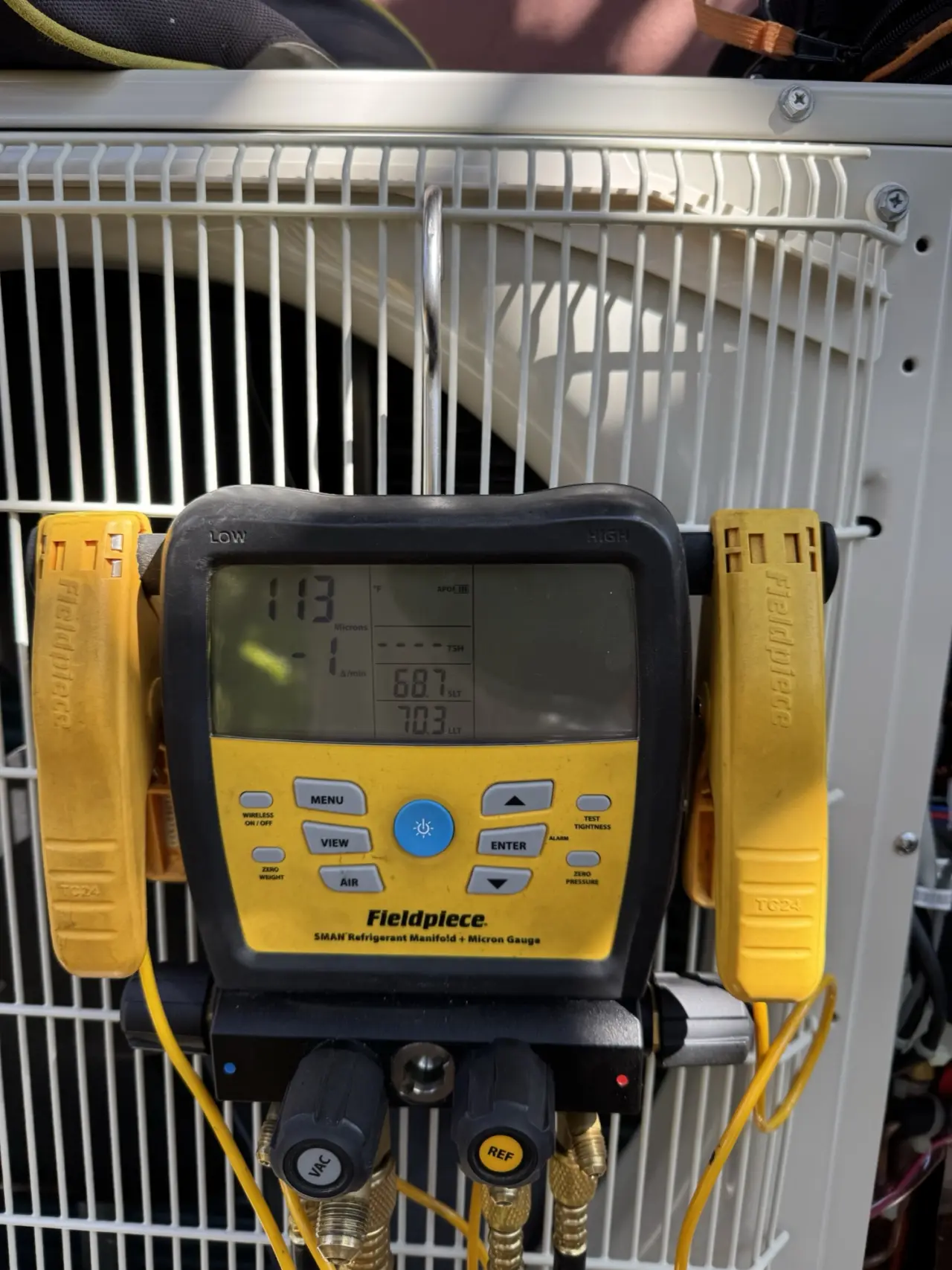 Micron gauge verifying vacuum on a Mitsubishi heat pump during installation in San Francisco