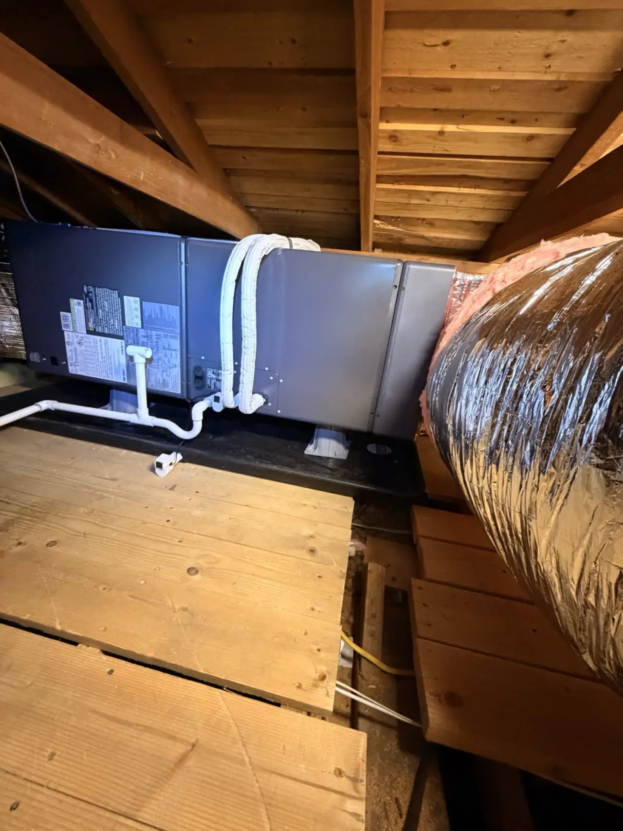 Carrier air handler installed in the attic of a San Mateo home with insulated linesets and condensate drain