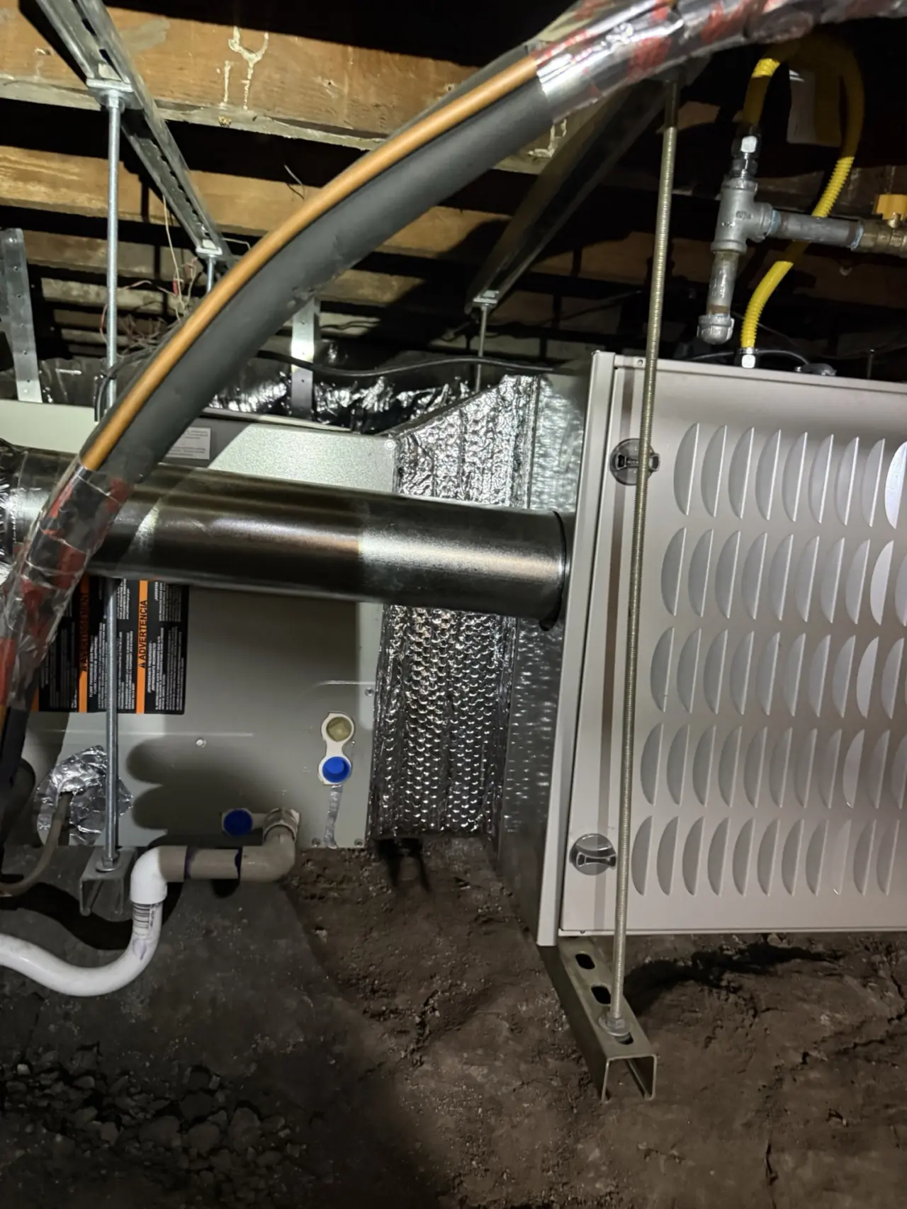 Side view of a Carrier furnace with refrigerant lineset and gas connections in Burlingame