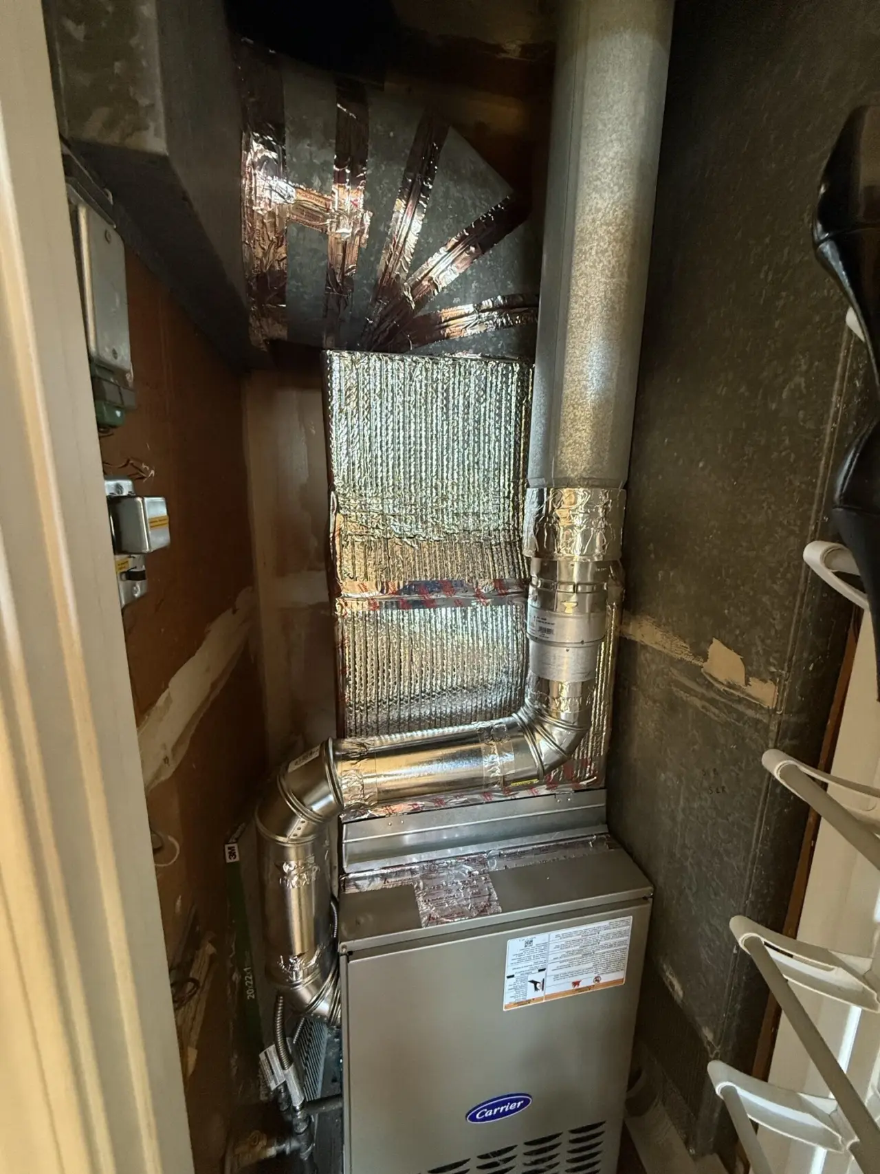 Carrier furnace connected to new galvanized ductwork in a Foster City closet