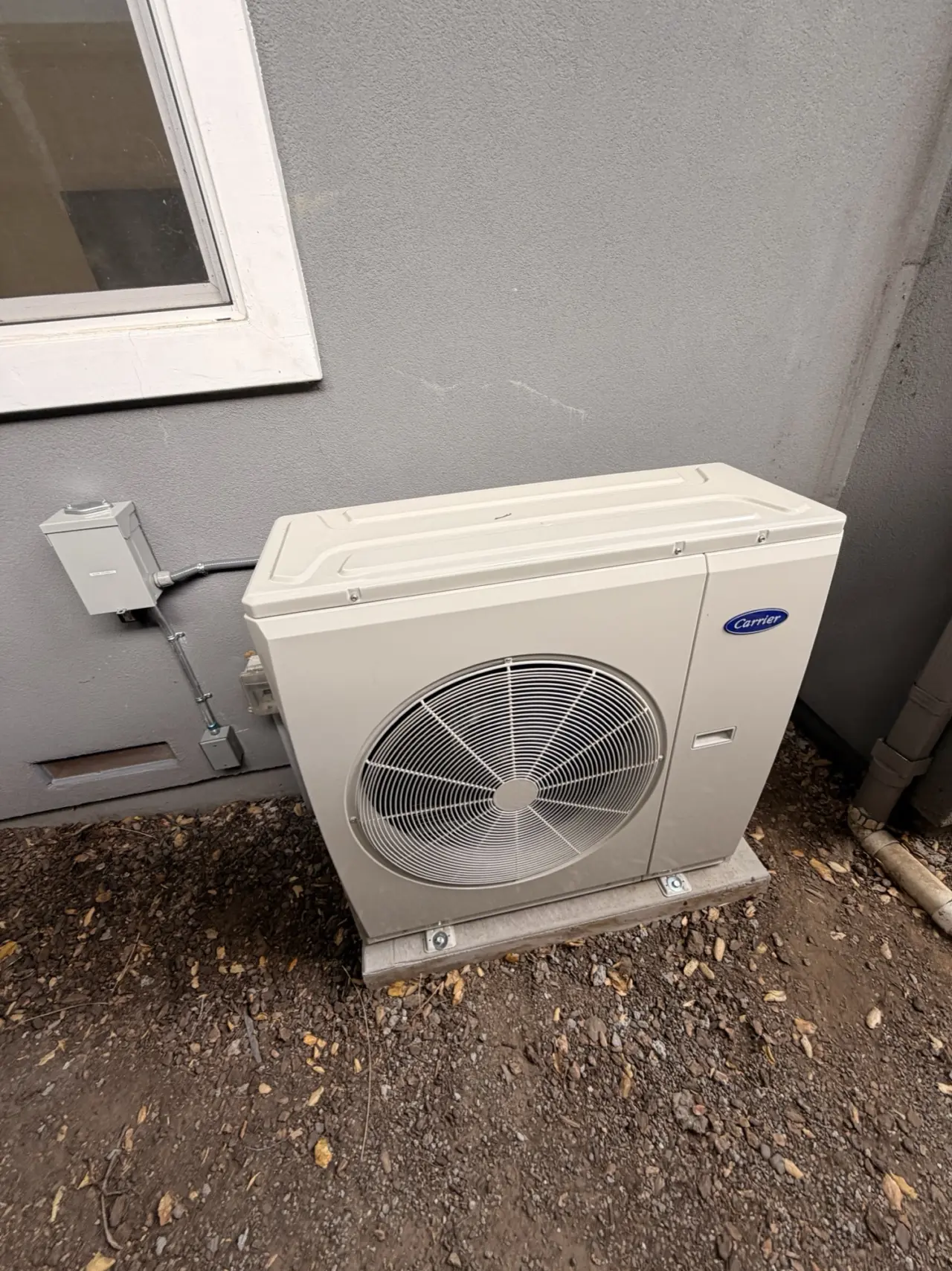 Carrier heat pump condenser and outdoor electrical disconnect installed in San Mateo