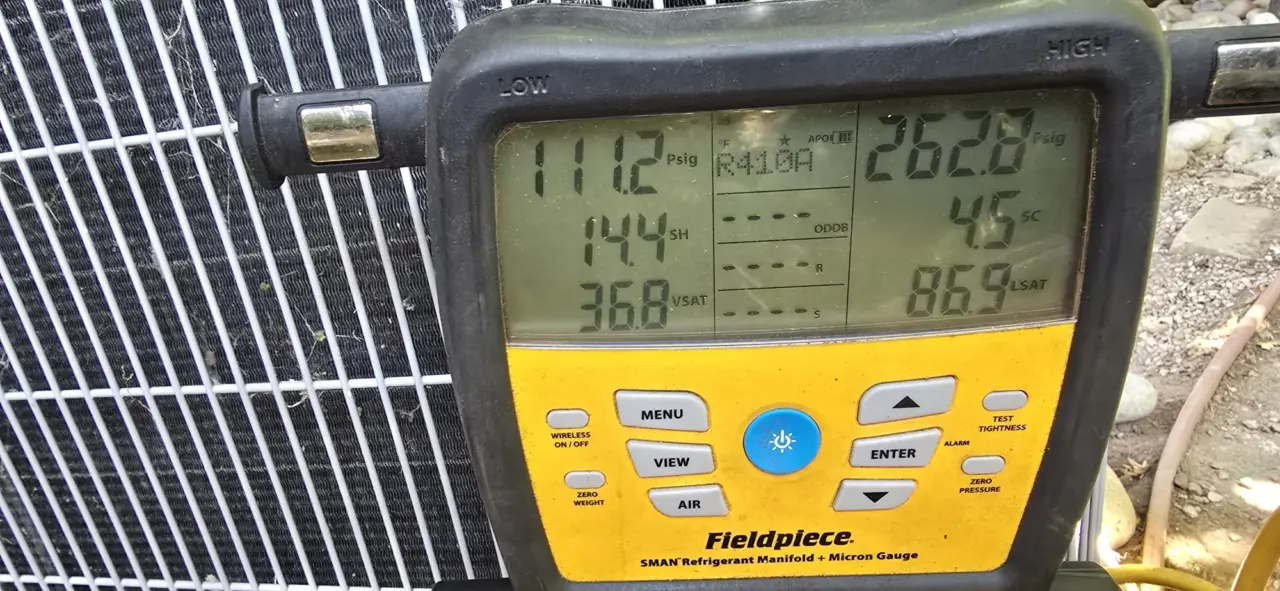 Gauges verifying R-410A pressures on a recharged AC system in San Carlos