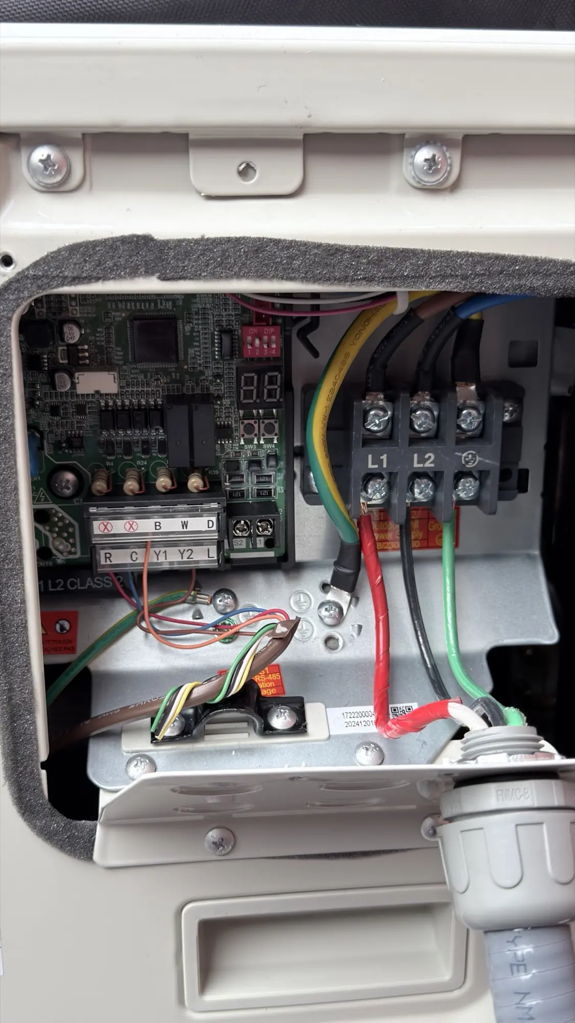Wiring terminals inside a Carrier heat pump outdoor unit in Mountain View