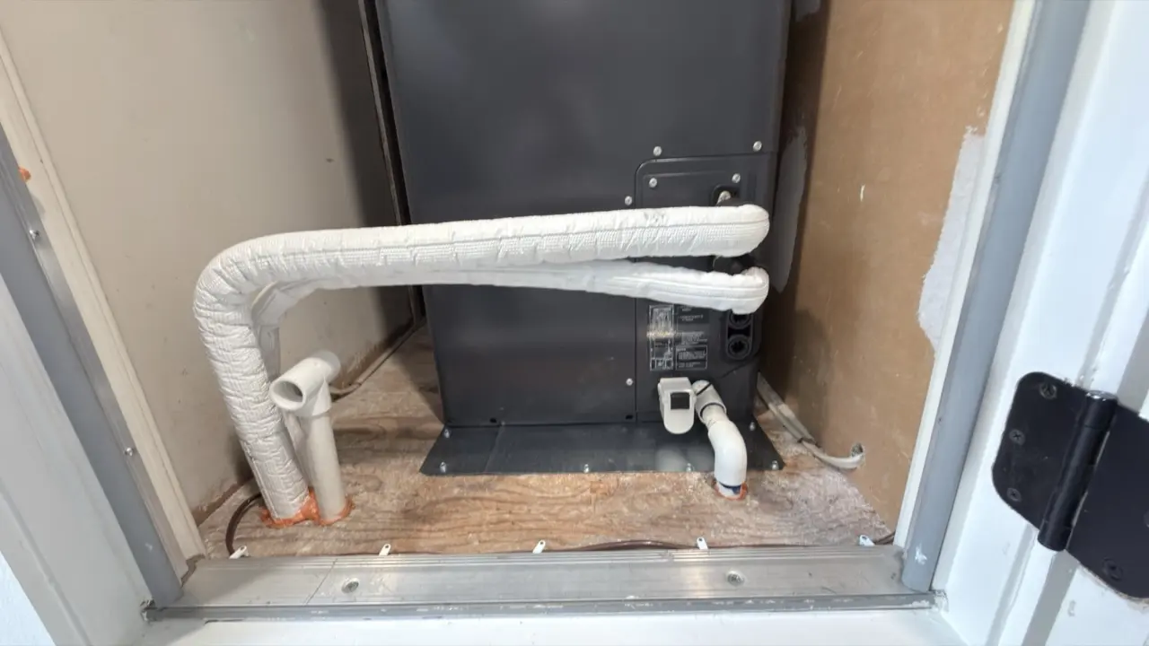 Insulated refrigerant lineset and condensate line behind a Carrier air handler in Mountain View