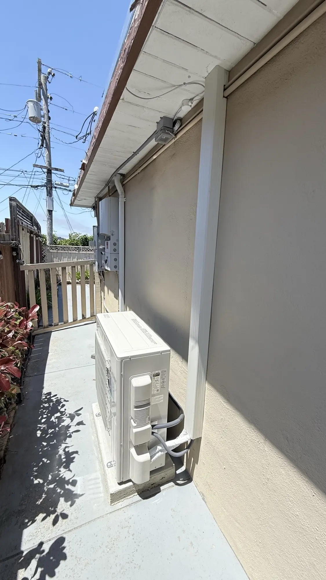 Mitsubishi heat pump condenser installed outside a San Bruno home