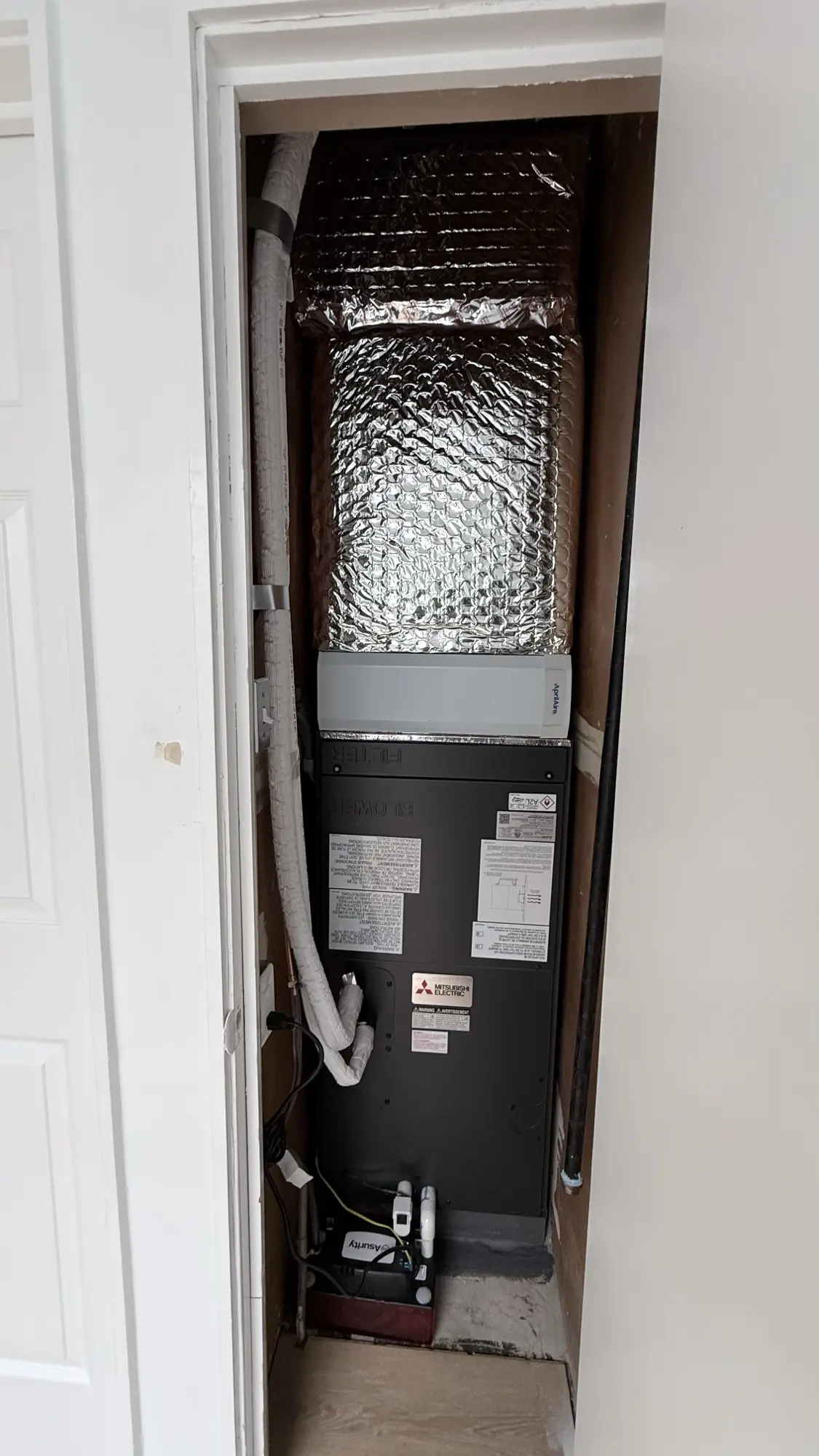 Mitsubishi air handler installed in a closet during a heat pump installation in San Bruno