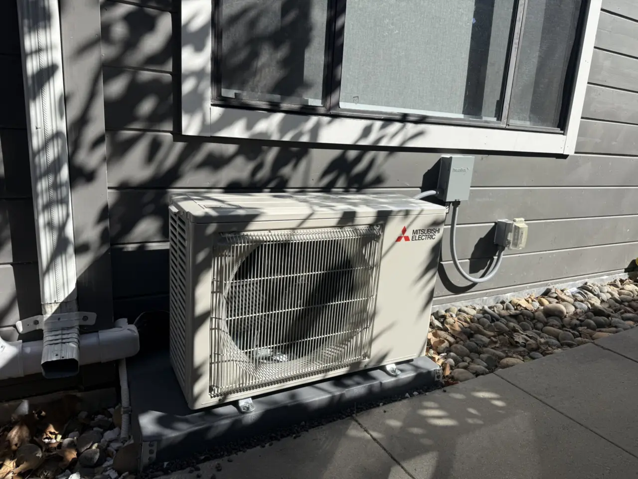 Mitsubishi outdoor condenser mounted beside window, Palo Alto ductless install