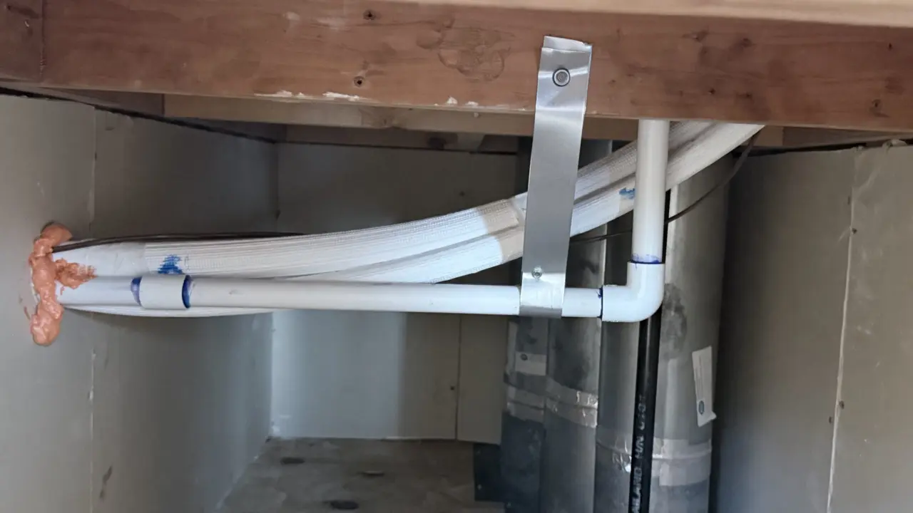 Insulated refrigerant lines and condensate drain routed under the furnace, San Francisco install