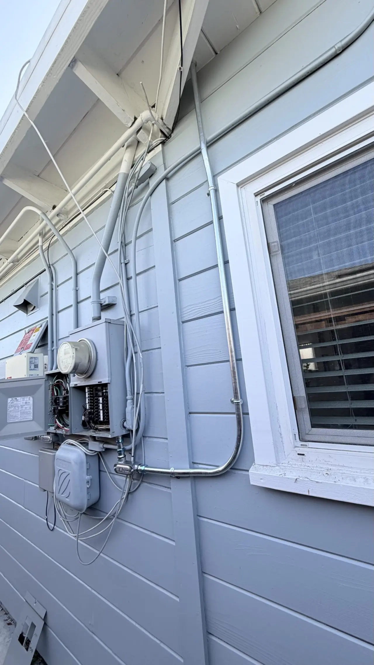 Conduit run to electrical panel for ductless heat pump install in San Mateo