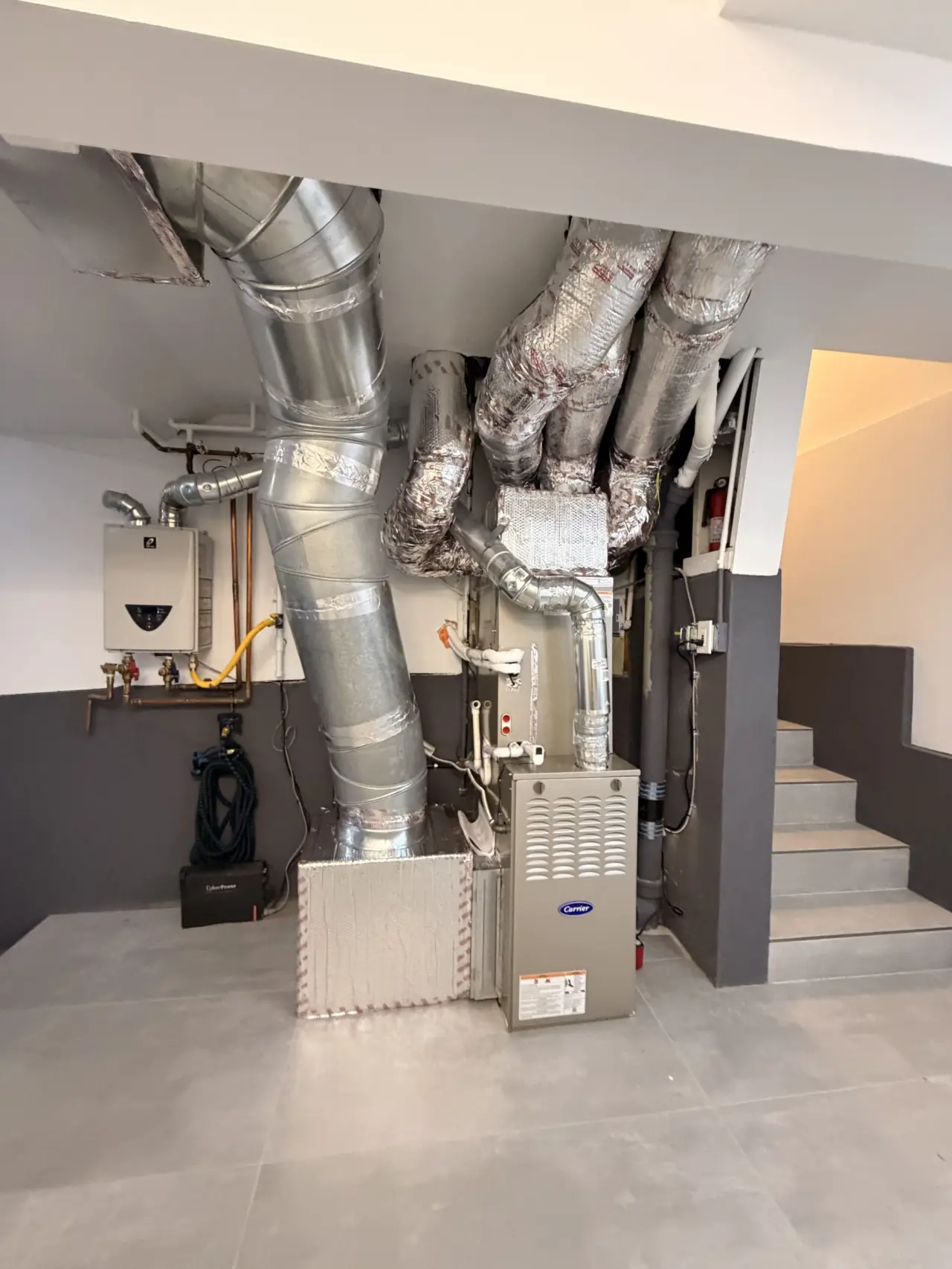 Wide view of the new Carrier dual fuel furnace and ductwork installation in San Francisco