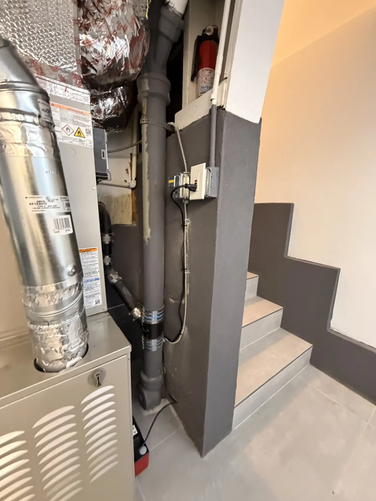 Finished Carrier furnace installation next to the water heater in a San Francisco utility closet