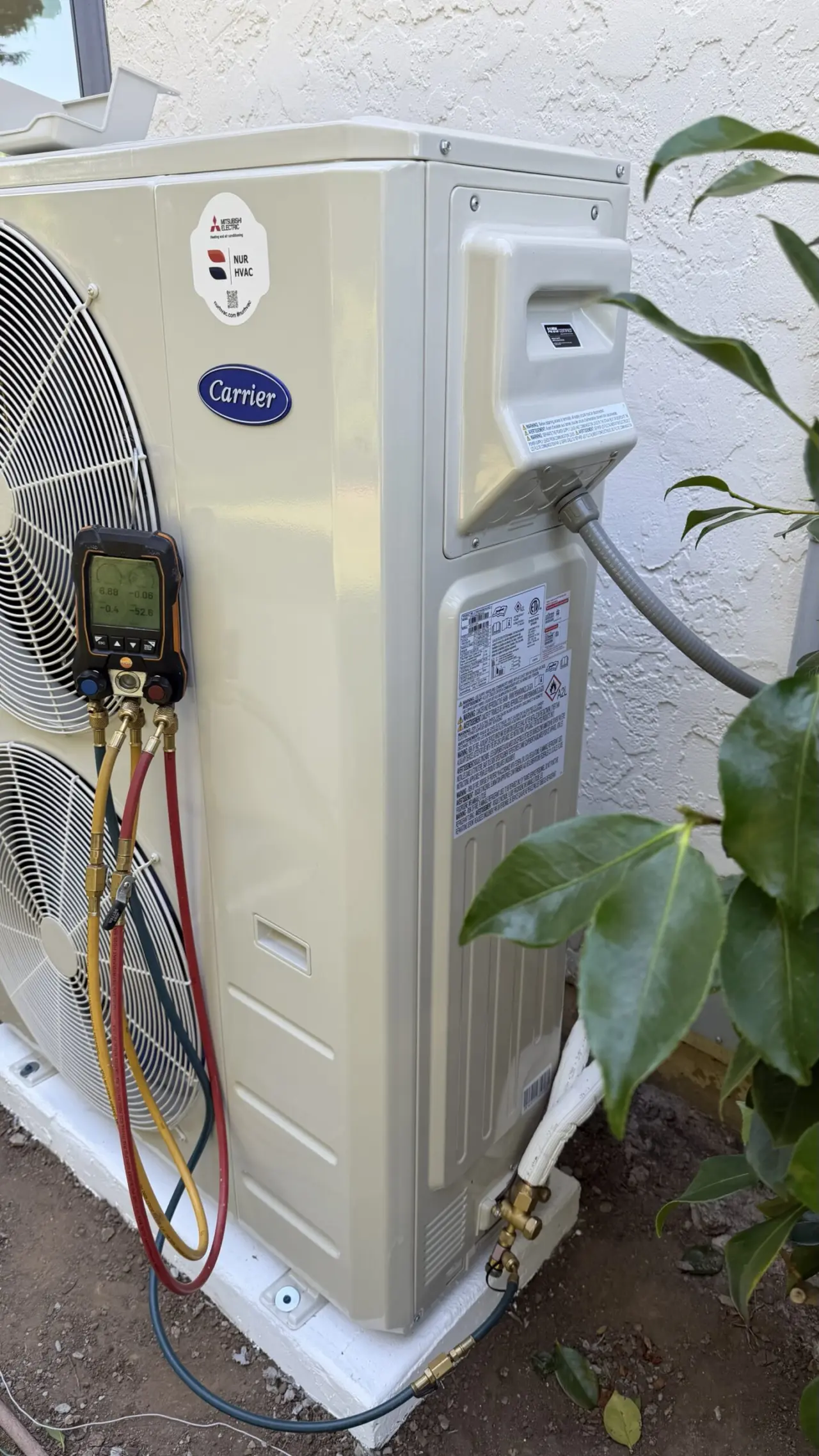 Close view of new Carrier heat pump outdoor condenser in Hillsborough