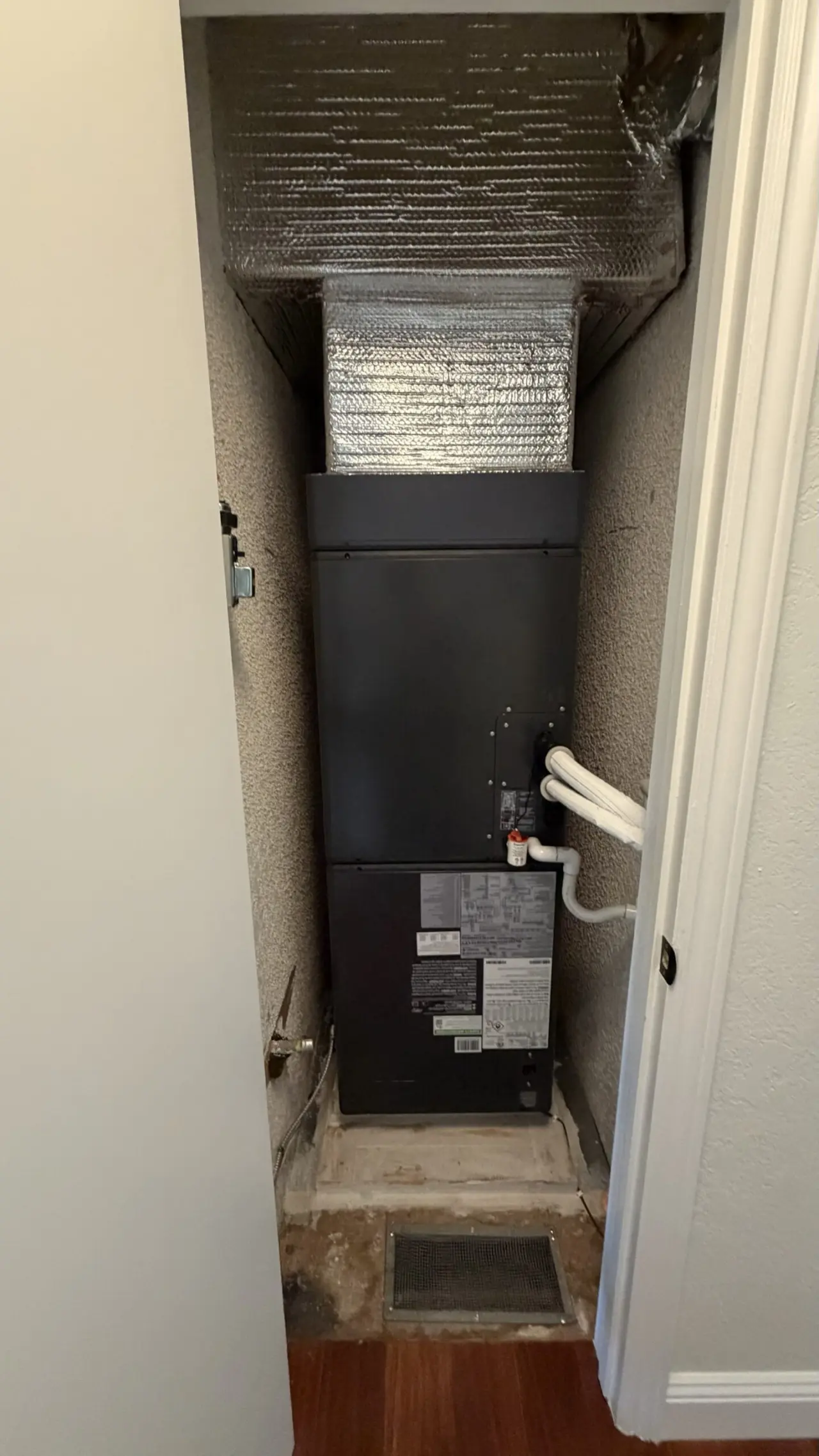 New Carrier heat pump air handler installed in a closet in a Hillsborough home