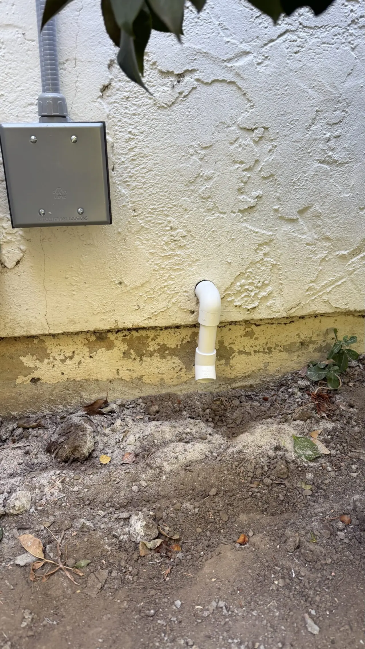 New condensate drain line routed outside a Hillsborough home