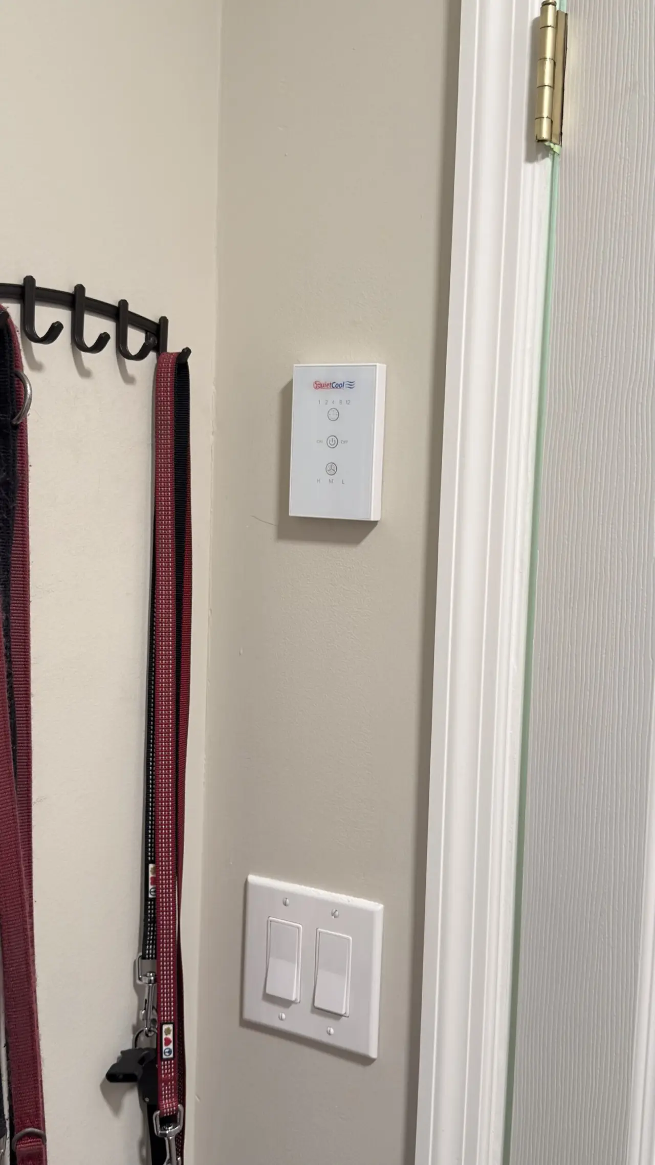 QuietCool whole house fan wall control panel installed near an entryway in Los Altos