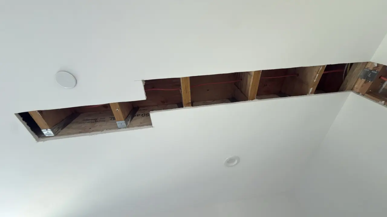 Ceiling opening showing line-set routing for the San Francisco mini-split installation