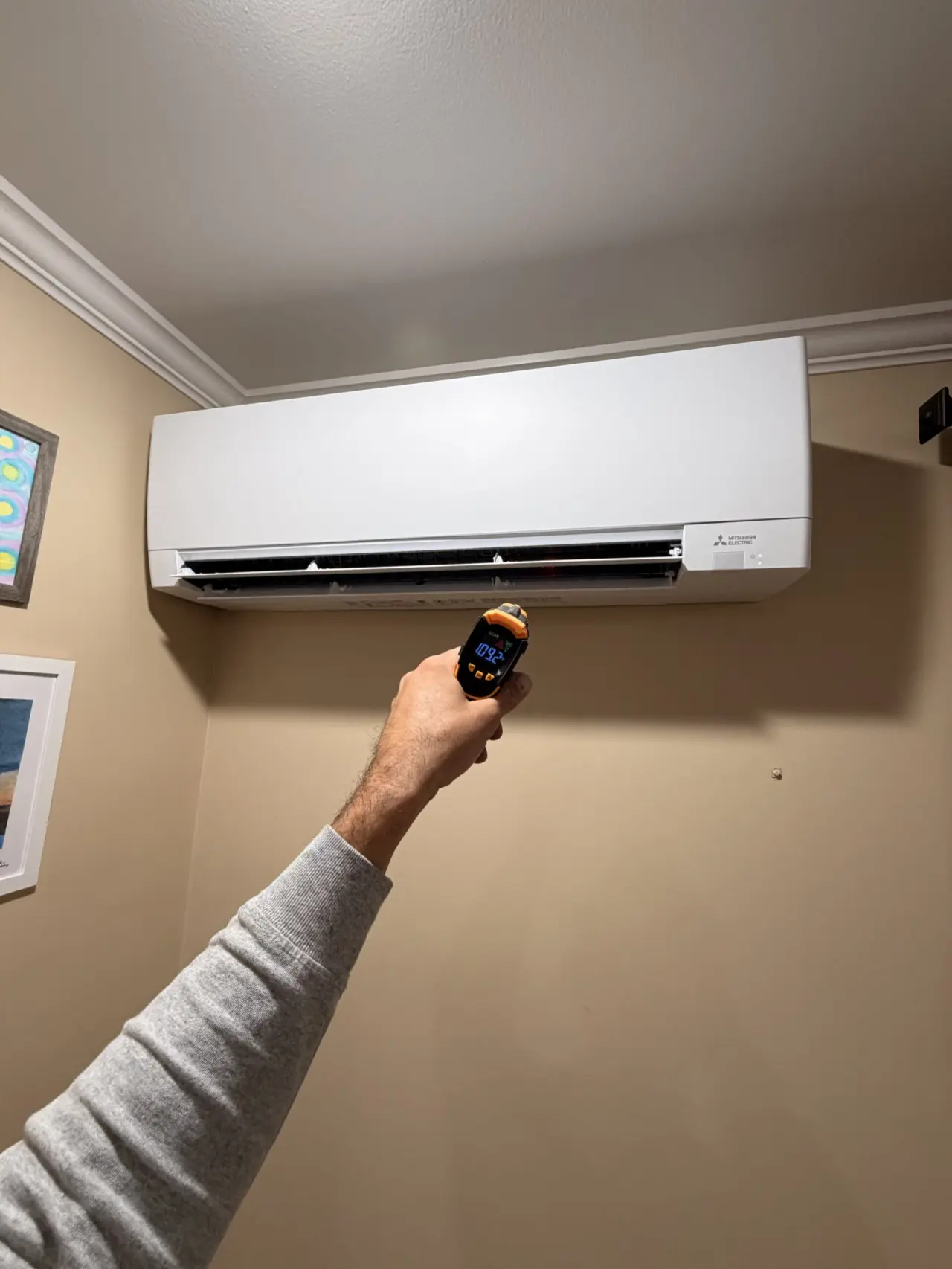 Mitsubishi indoor wall unit installed with temperature check in Brisbane, CA home