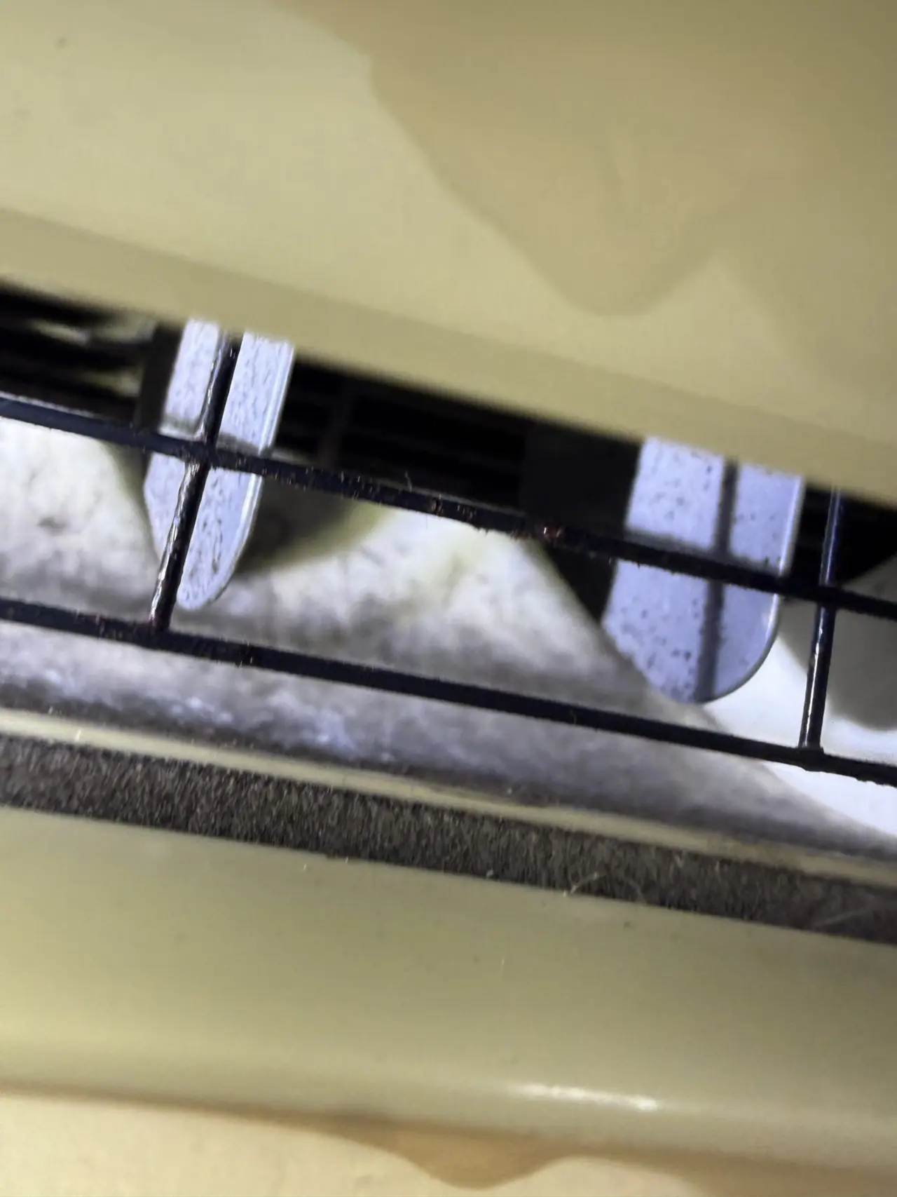 Dust buildup on the intake grille of a Mitsubishi ductless indoor unit before cleaning in Mountain View