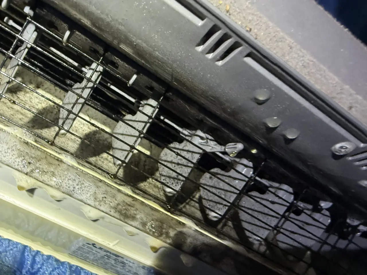 Dirty blower wheel inside a Mitsubishi ductless indoor unit before cleaning in a Mountain View home