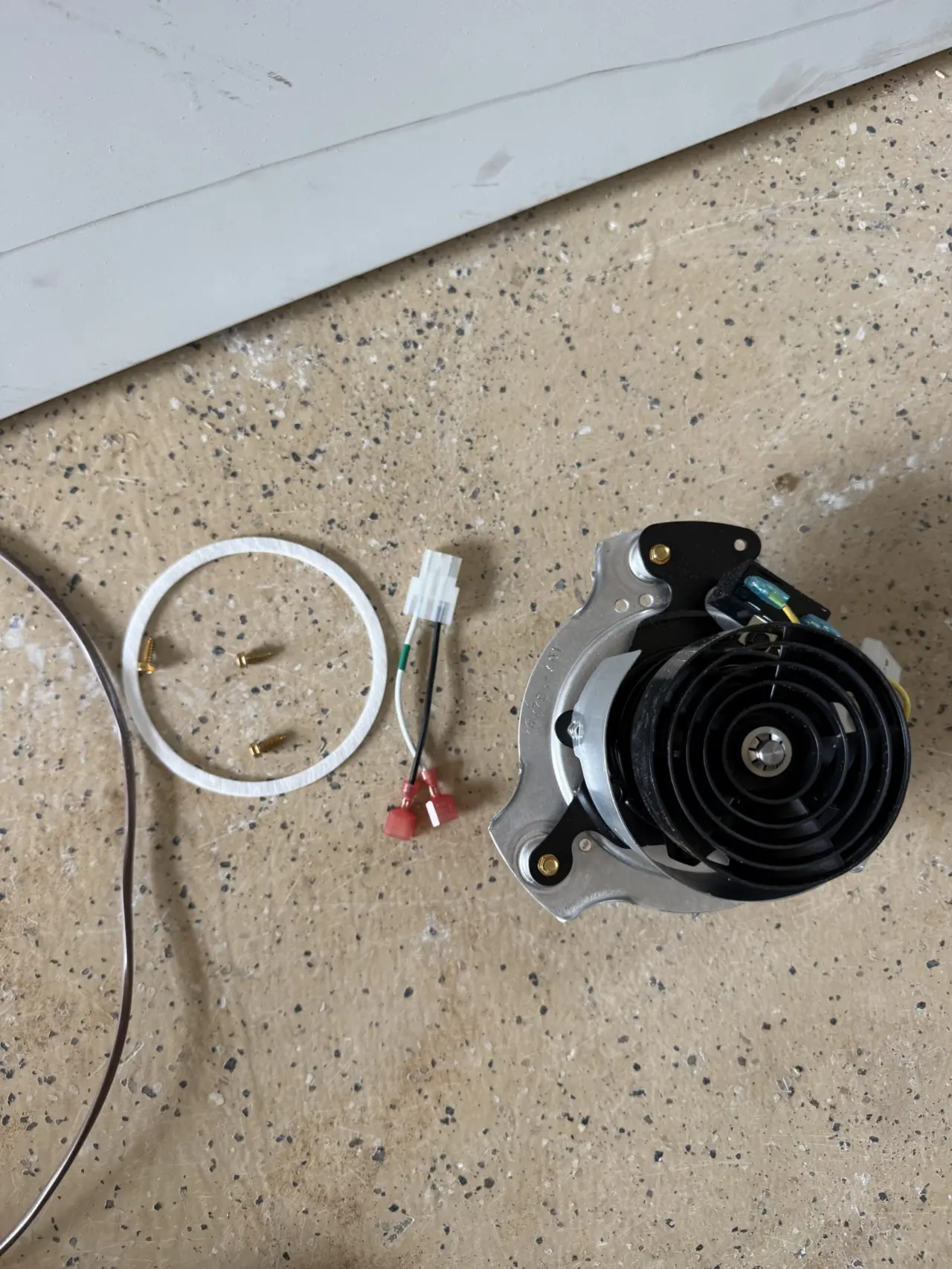 New furnace inducer motor assembly and gasket ready for installation