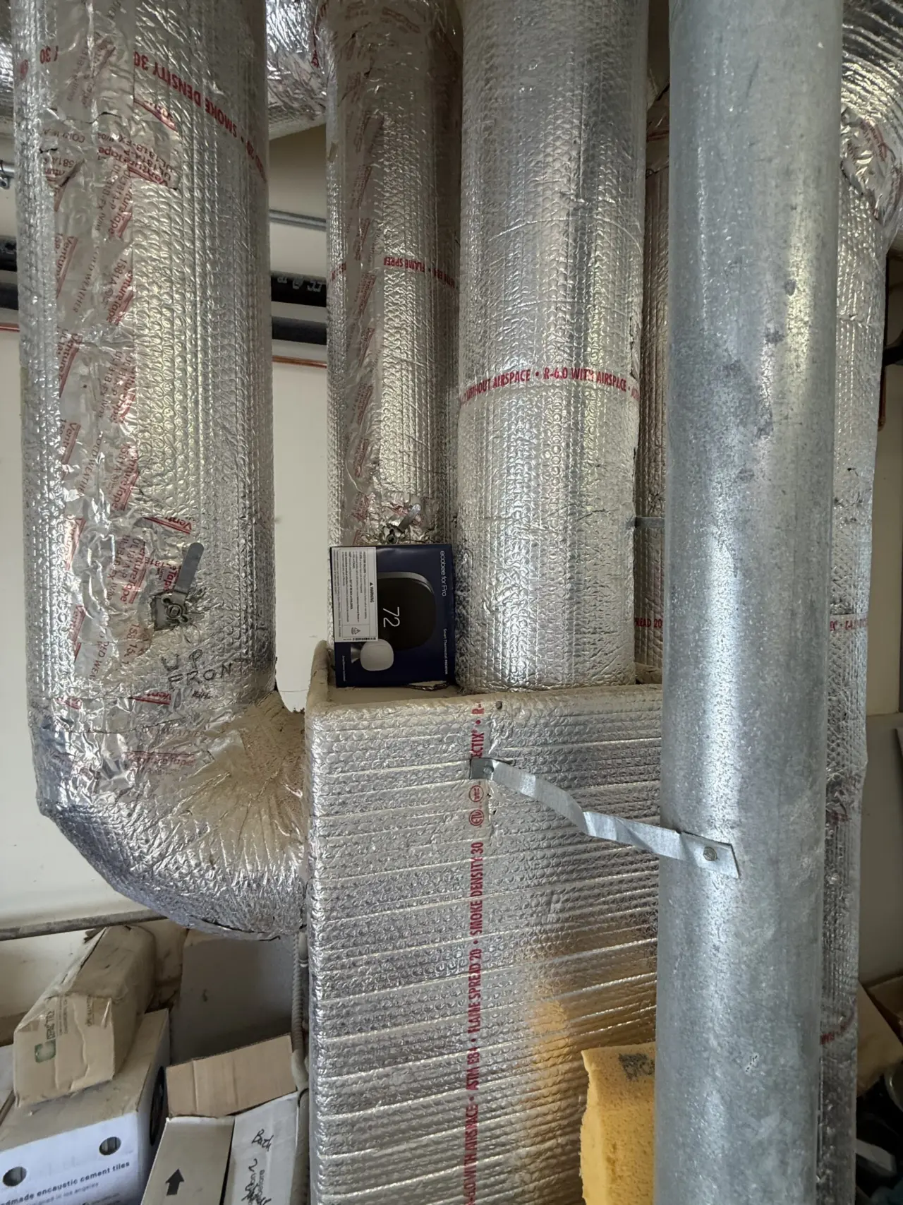 Insulated ductwork and new ecobee thermostat box in a San Francisco furnace closet