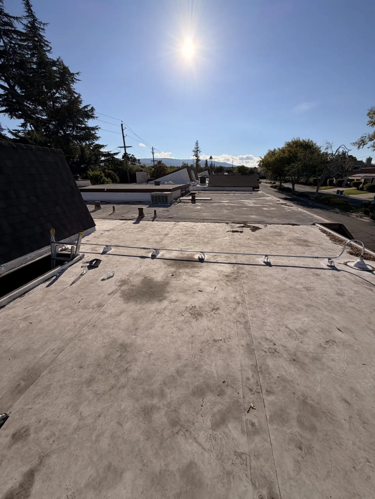 Flat rooftop view with new heat pump line set installed in Cupertino
