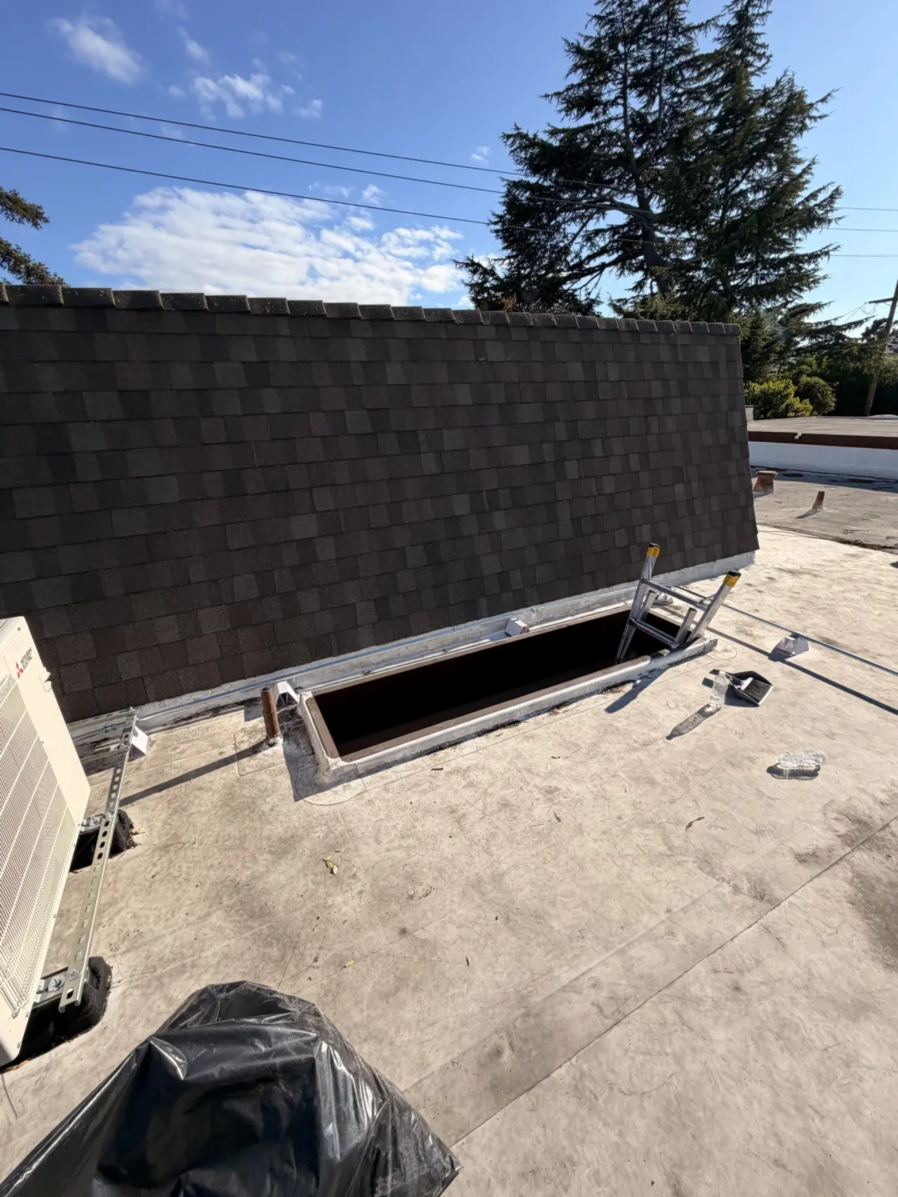Roof opening prepared for Mitsubishi heat pump line set routing in Cupertino