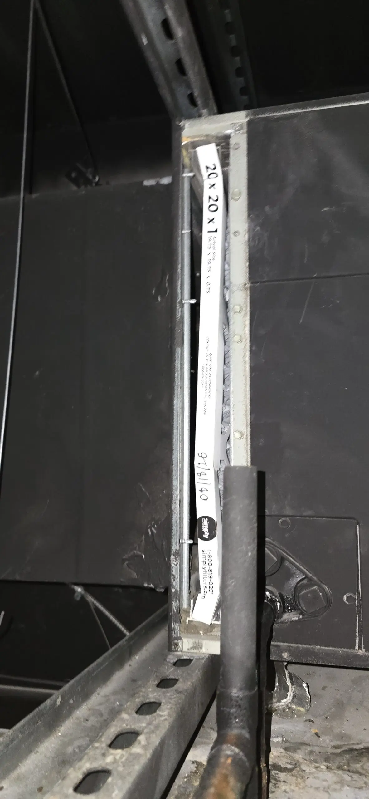 New filter fitted into the return slot of a Millbrae above-ceiling HVAC system