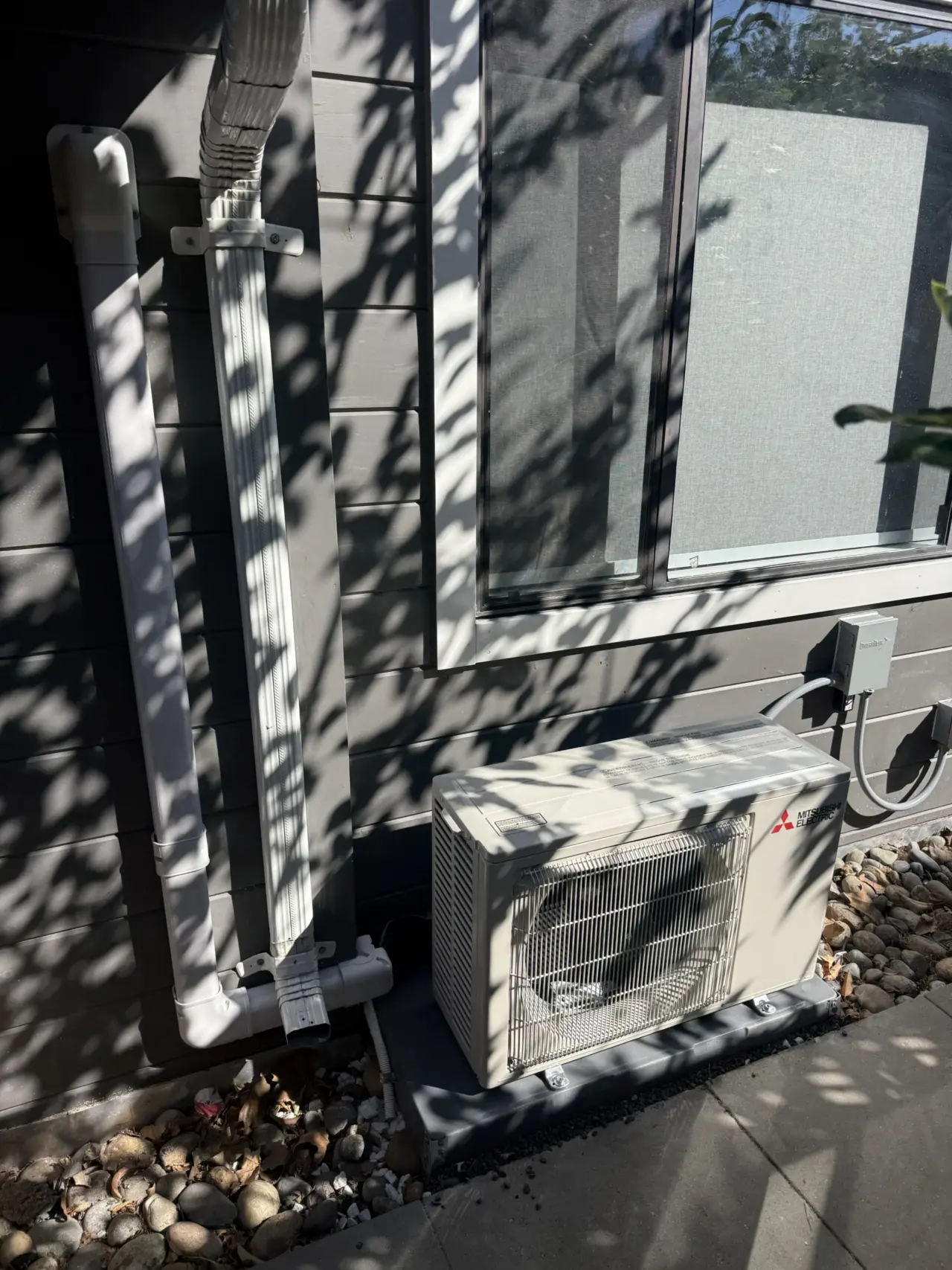 Mitsubishi ductless heat pump outdoor unit installed on wall bracket, Palo Alto home
