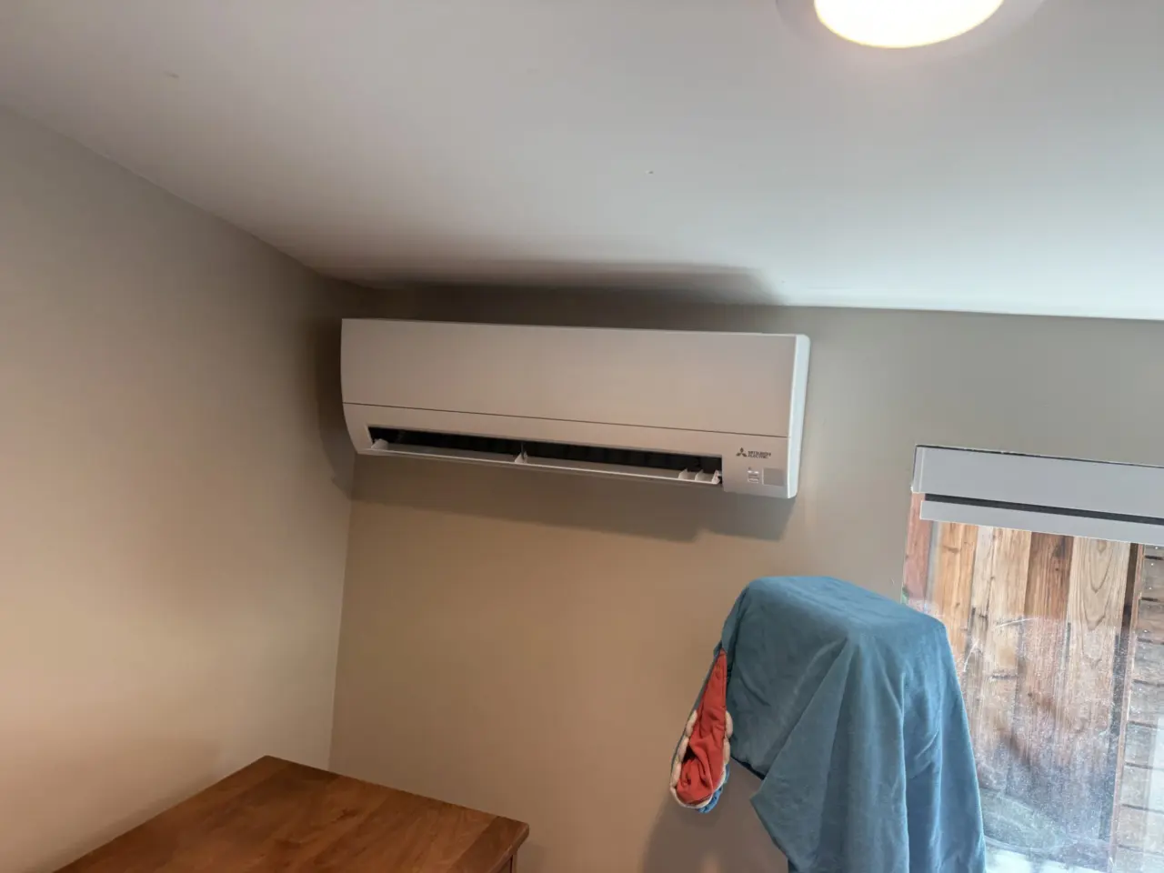 Mitsubishi indoor wall-mounted heat pump head installed in Palo Alto bedroom