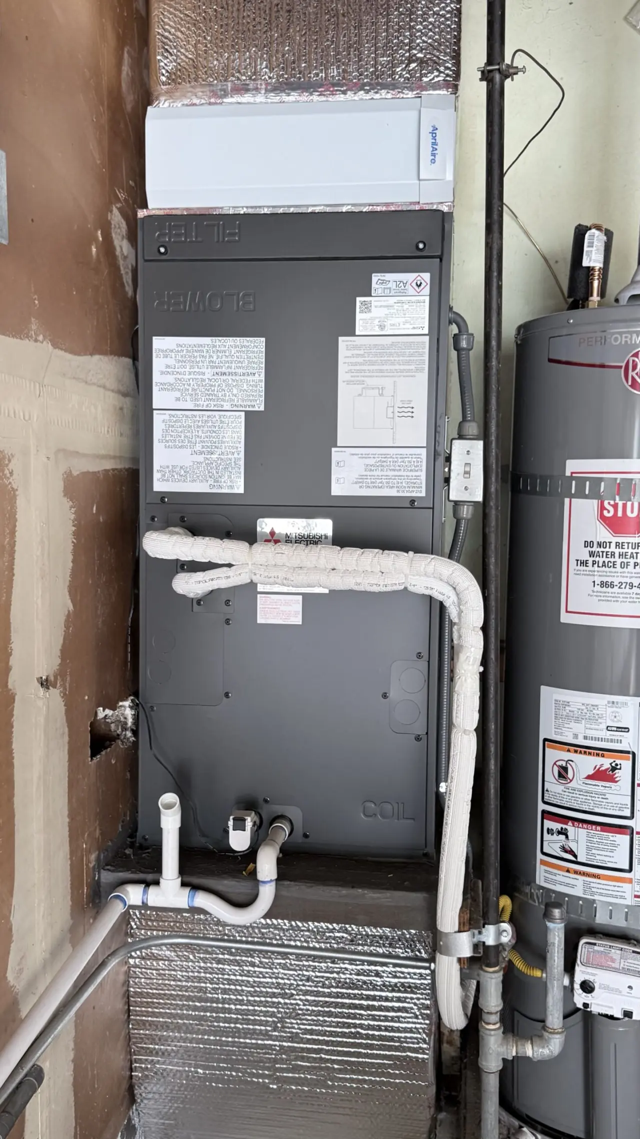 Close-up of new Mitsubishi Electric air handler with insulated refrigerant lines in San Mateo