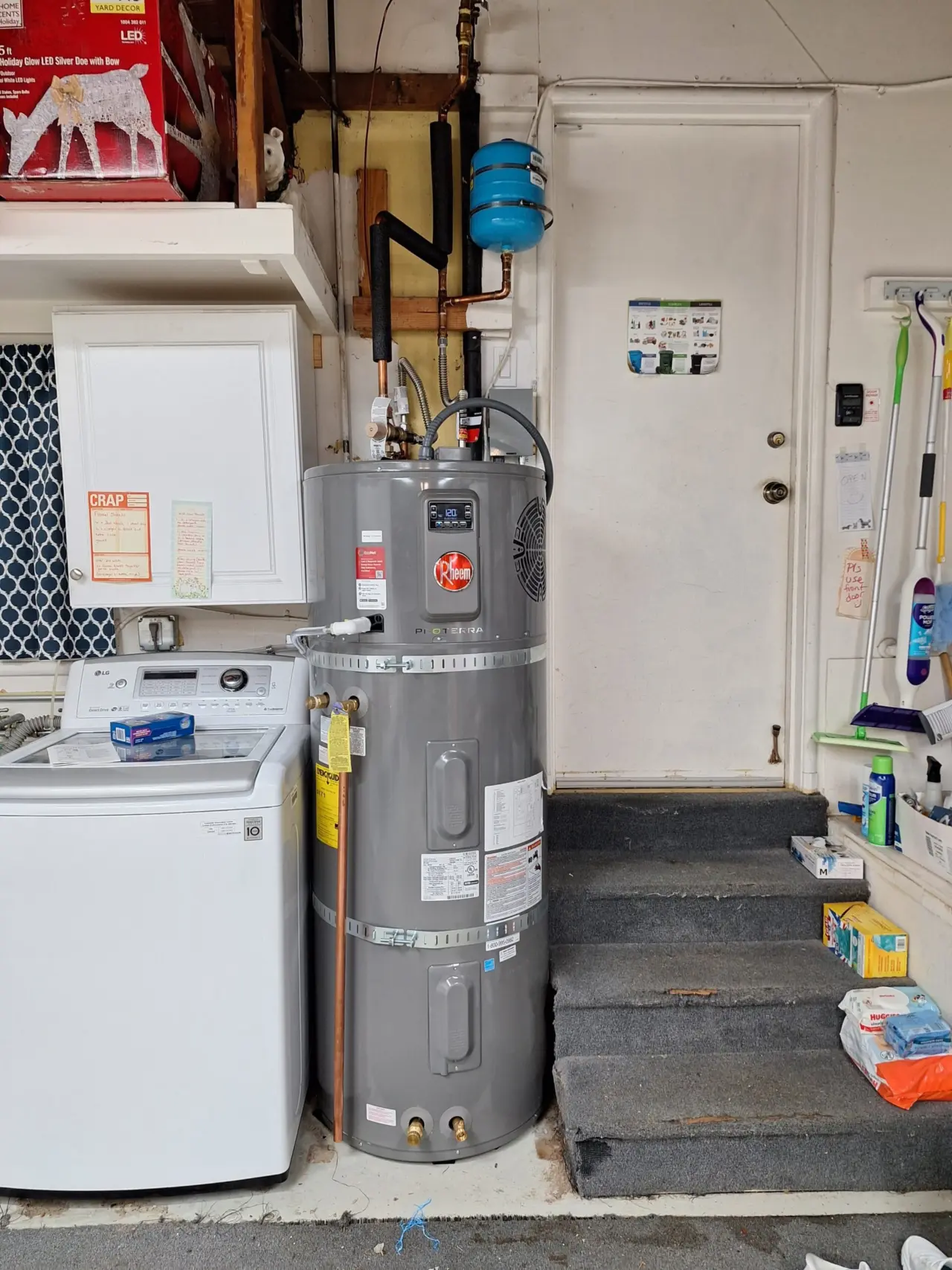 Rheem ProTerra heat pump water heater installed with seismic straps next to the laundry in a San Mateo garage